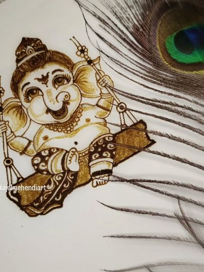 The final Ganesha portrait, styled with a peacock feather. These small artistic touches make the design even more special.