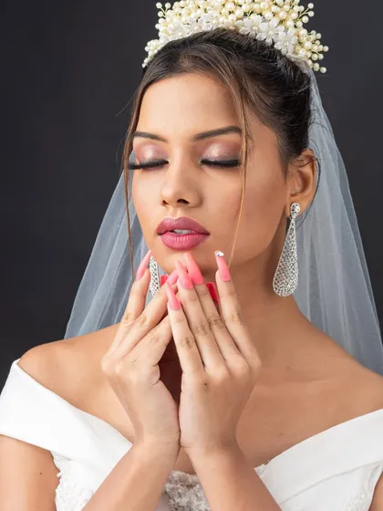 A close-up on the soft pink and silver eye makeup for this Christian bridal look. Notice the delicate blending and the choice of lashes to keep the look ethereal.