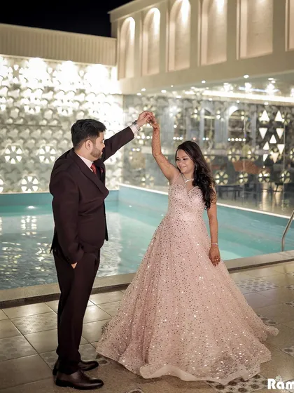 A fun and romantic shot of the couple dancing by the pool at their engagement venue. This image captures the celebratory and glamorous atmosphere of the night.