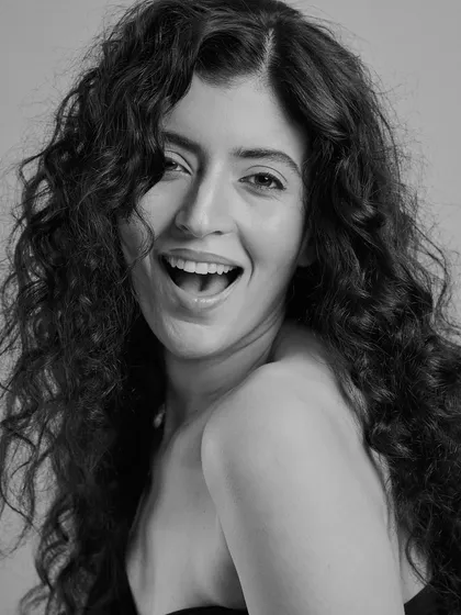 A joyful, candid moment. This shot proves that monochrome can be just as full of life and personality. The natural hair and makeup feel authentic and beautiful.