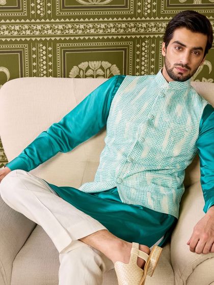 I love playing with bold colors. This vibrant emerald green silk kurta is layered with a textured, light green patterned jacket for a striking and memorable look.