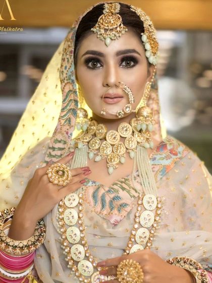 A unique off-white jewellery set with large, coin-like details. This is a very royal and distinctive look for a bride who wants to make a statement.