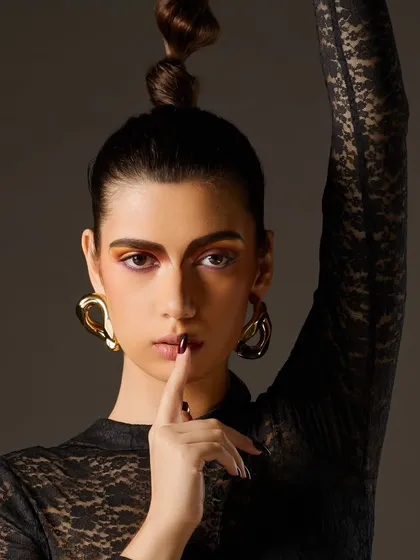 Another angle of this creative editorial look, highlighting the sharp lines of the makeup and the confident attitude of the model.