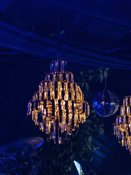 A close-up of the elegant crystal chandeliers that added a touch of classic luxury to the modern, vibrant party decor.