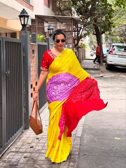 A full-length shot of me in a vibrant yellow and red bandhani saree. This image kicks off a series showcasing my love for sarees, featuring a traditional yet eye-catching look.