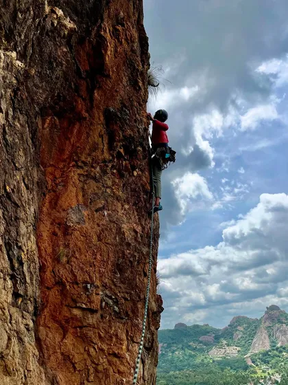 The adventure of multi pitch climbing unfolds on the sheer rock faces near Bangalore. Here, a climber navigates a vertical world with breathtaking views of the Ramanagara landscape below, showcasing the focus and endurance these big climbs require.