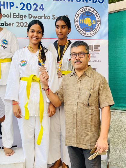 An official presents medals to our victorious students at the Delhi State Championship.