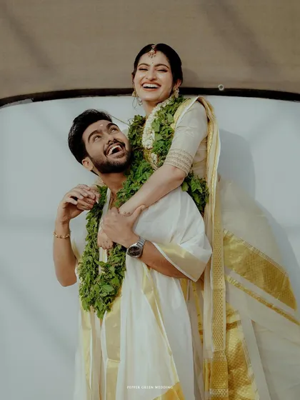 A fun and candid moment of the couple sharing a laugh after their temple wedding ceremony.
