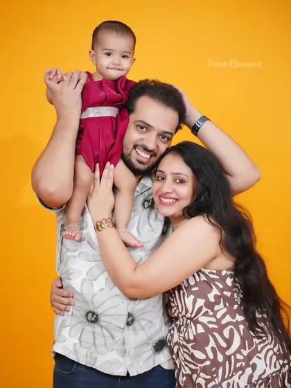 A sweet family hug against a warm, sunny backdrop in our studio. This classic pose is perfect for capturing the closeness of your family.
