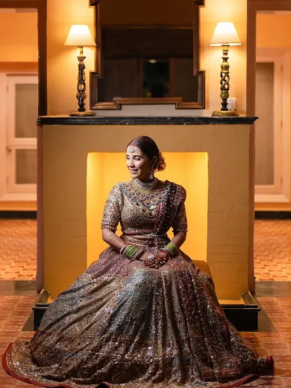 A moment of regal elegance. For her reception, we styled this bride in a timeless, multi-hued Tarun Tahiliani ensemble paired with heritage gold jewelry, creating a look that was different from her red bridal outfit but equally graceful.
