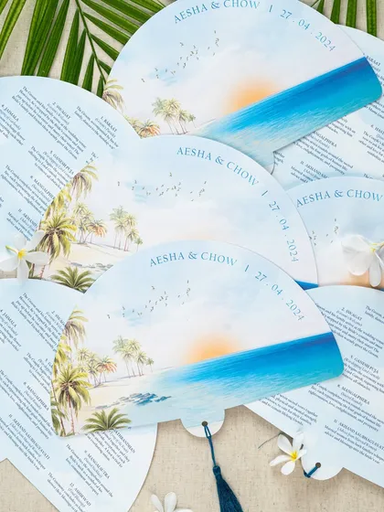 For a destination wedding in Los Cabos, I designed these unique ceremony programs as hand fans. They were perfect for the warm beach setting, featuring a beautiful watercolor of the seaside venue and the full itinerary.