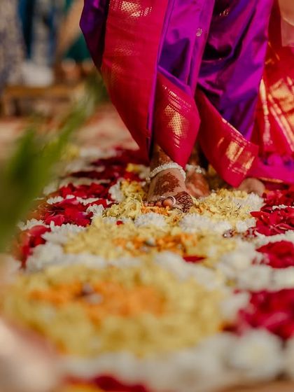 A detail shot of the bride's feet walking on the floral path during the Saptapadi.
