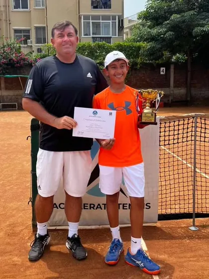 The winner of our U12 singles event at the academy tournament, with coach Todd Clark.