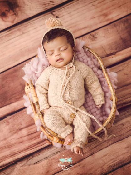 We love simple, neutral setups that feel warm and organic. This baby is sleeping in a knit romper, nestled in a hanging prop for a cozy, minimal shot.