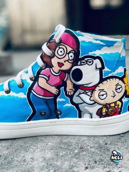 The Family Guy side of our cartoon mashup high-tops. This image shows Meg, Brian, and Stewie Griffin painted against a sky-blue background.