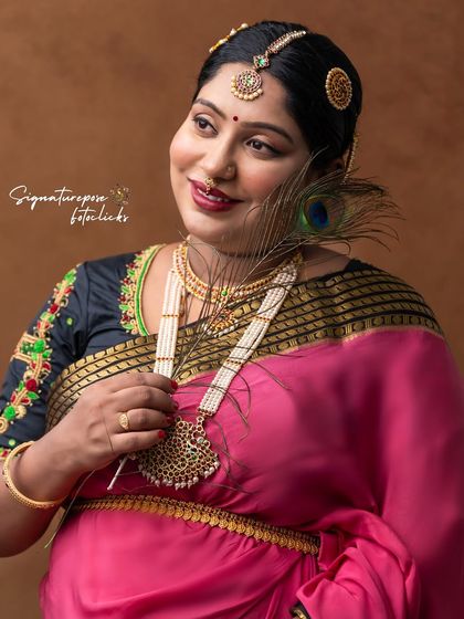 A close-up portrait showcasing the intricate jewelry and serene expression of the mother-to-be.