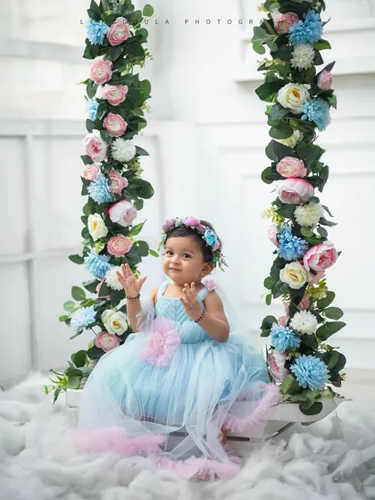 A full view of the magical floral swing setup. We create a dreamy atmosphere with soft clouds of fluff and delicate flowers for our fairy-themed shoots.