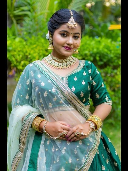 A lovely portrait showing the complete look with the sheer dupatta draped gracefully.