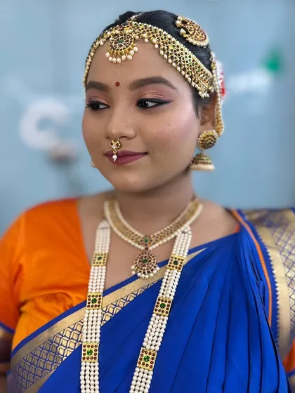 A close-up of the Bharatanatyam makeup, showing the defined eyes, traditional jewellery, and neat hairstyle required for a stage performance.