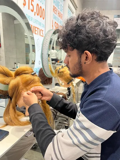 Our students getting hands-on training in hair extensions, a popular and profitable salon service.