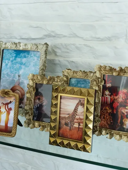 A display of our diverse photo frame collection, from ornate gold designs to modern geometric shapes. Each frame is crafted to give your memories the unique and stylish home they deserve.