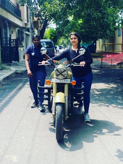 A student practices walking her bike, a fundamental skill. Even our graduates remember and respect the basics.