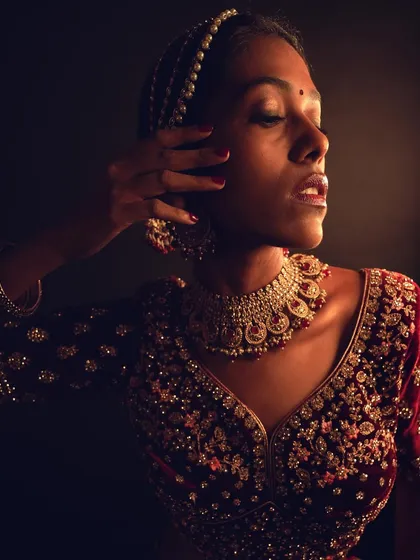 This image captures the beautiful highlights and dewy texture of the skin under focused lighting.