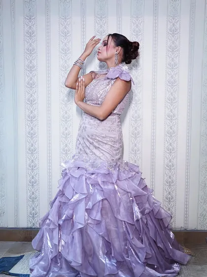 A full-length side profile, showing the beautiful silhouette of the gown.