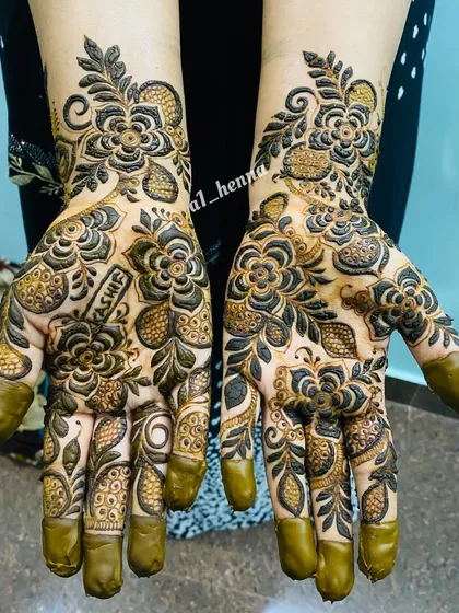 A beautiful example of a custom bridal design, including the bride's name "Yashfeen" hidden within the floral patterns. My organic cones make these personalized touches easy to create.