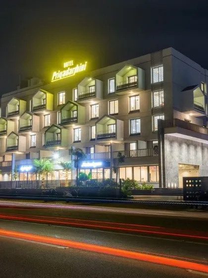 We designed this business hotel near Hampi to reflect modern architectural elegance while honoring the region's tradition of hospitality. The night-time illumination highlights the building's structured facade and inviting ambiance.