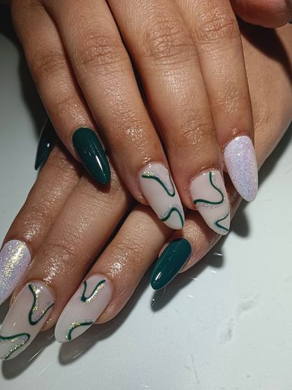 This client had a unique color combination in mind, and I loved bringing it to life. This set features dark green, glitter, and a nude base with abstract green swirl art.