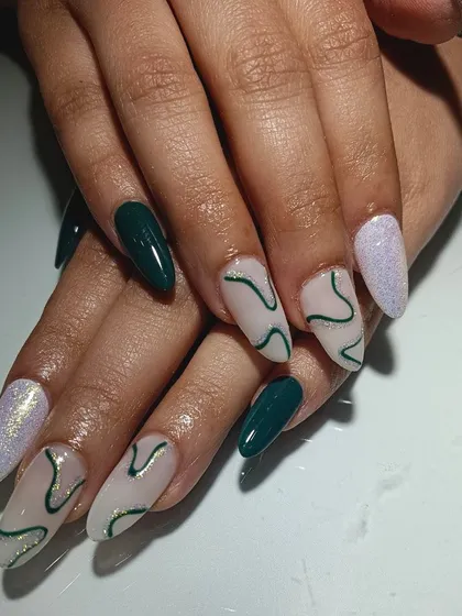 I love unique color choices. This gorgeous scheme combines deep green, shimmery lilac, and a nude base with abstract green swirl art.
