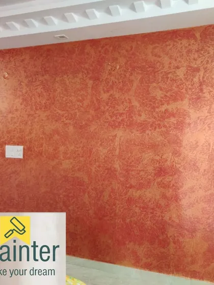 This is an example of our vibrant textured wall painting. We used a sponge technique with layered shades of orange and gold to create a dynamic, energetic surface with significant depth and character.