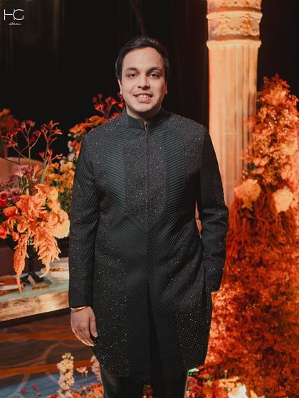 A portrait of Piyush Bansal in his wedding attire. The intricate, shimmering detail of the sherwani is visible, designed for a grand yet personal celebration.