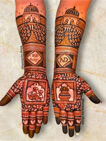 A classic bridal design with traditional wedding ceremony elements. The palms feature a dhol and a kalash, with the words 'Shubh Vivah' (Auspicious Wedding) and the couple's initials 'ND'.