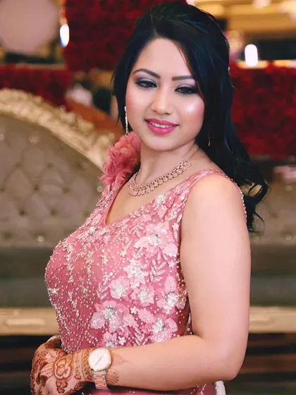 A beautiful portrait of the bride-to-be at her engagement party, smiling in her pink floral gown.
