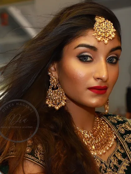 A close-up on this bold and beautiful makeup. The contrast between the bright silver eyeshadow and the deep red lip is striking and perfect for a festive or party look.