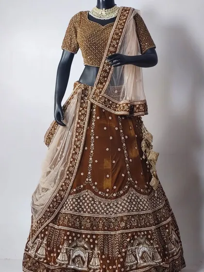 Why buy when you can rent? This elegant brown bridal lehenga with a fully embroidered gold blouse is a unique and sophisticated option for your big day.