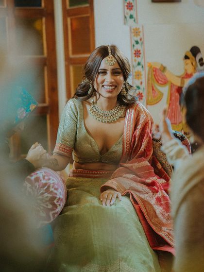 A candid shot of the bride's infectious laughter during her Mehendi ceremony, a moment of pure happiness.