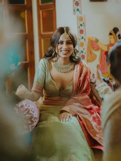 A candid shot of the bride's infectious laughter during her Mehendi ceremony, a moment of pure happiness.