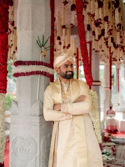 For the distinguished groom, we crafted this elegant silk sherwani in a classic cream color. The subtle embroidery on the collar and cuffs adds a touch of royalty, making it a perfect choice for a traditional wedding ceremony.