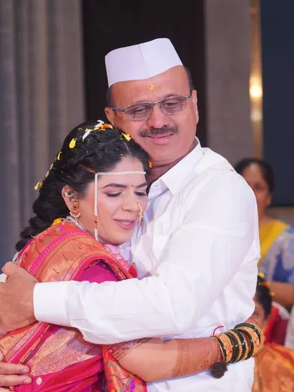 A touching embrace between father and daughter. These candid, emotional moments are what make a wedding album truly special and personal.