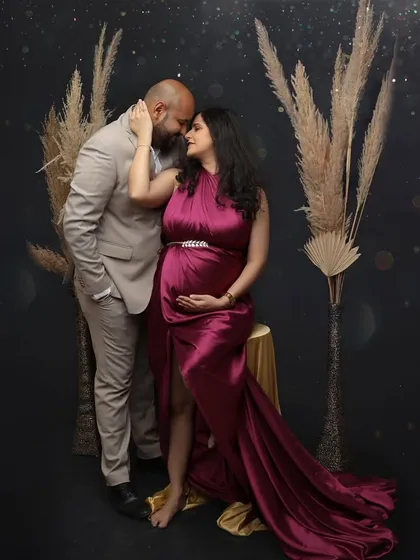 A stylish and intimate portrait of a couple. The moody lighting and their close embrace create a romantic and sophisticated atmosphere.