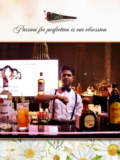 A bartender at a large wedding in Hyderabad, ready to serve from a bar stocked with premium spirits.