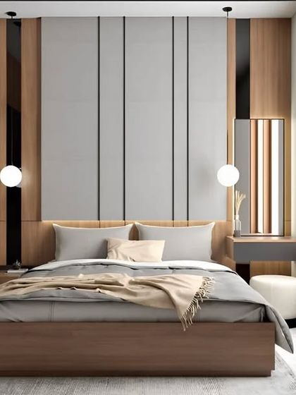 A well-designed bedroom featuring a custom wardrobe, a bed with an upholstered headboard, and an integrated dressing table, all in a cohesive wood and grey theme.