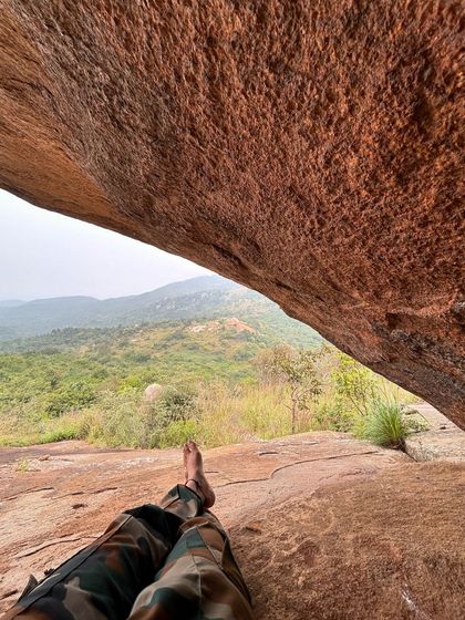 A moment of peace, relaxing under a rock overhang on the Skandagiri trail.