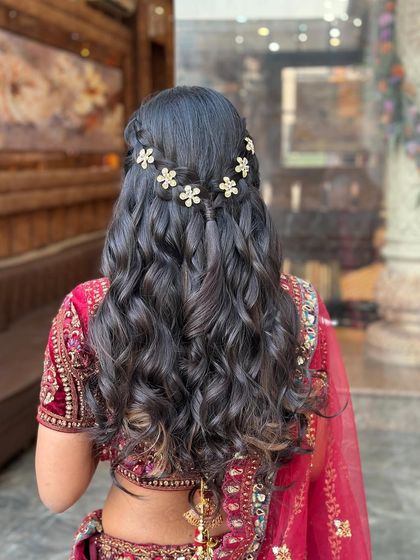The beautiful floral accessories stand out against the dark hair in this half-updo.