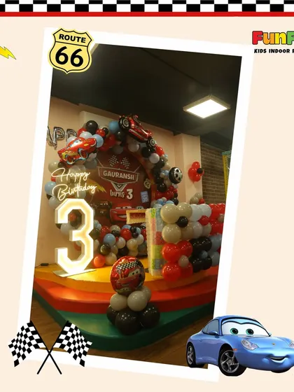 Welcome to the races. This Disney's Cars themed party featured a custom backdrop with a light-up number '3' and a balloon arch designed to look like a finish line.