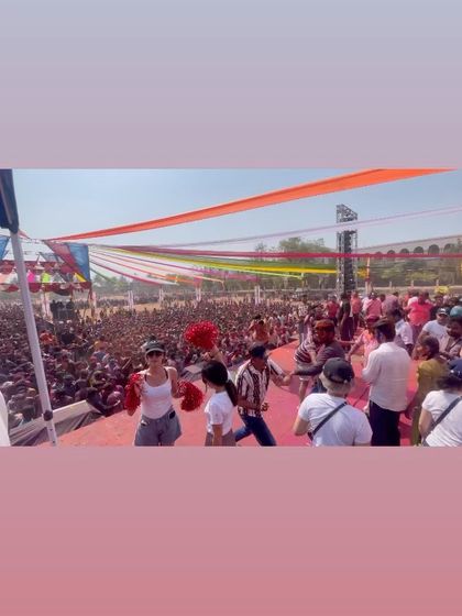 Another wide view of the stage during the Holi festival. The vibrant decorations and huge crowd create an incredible atmosphere for a daytime DJ set.