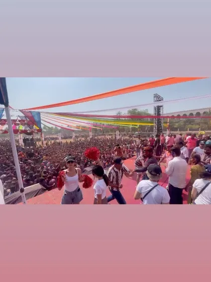 Another wide view of the stage during the Holi festival. The vibrant decorations and huge crowd create an incredible atmosphere for a daytime DJ set.